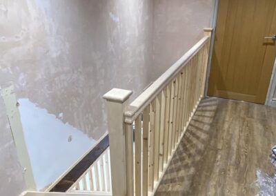 Landing balustrade with square newel post and spindles fitted by GT Joinery